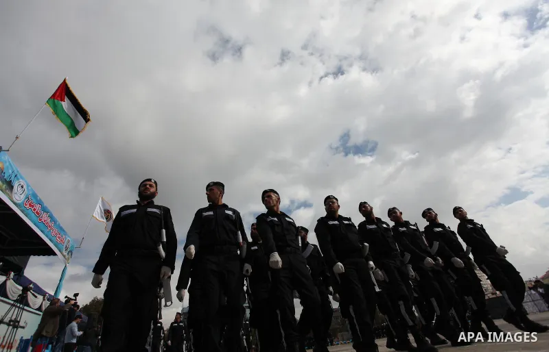 Palestinian policemen march during a graduation ceremony in Gaza City on January 21, 2017. Photo by Ashraf Amra