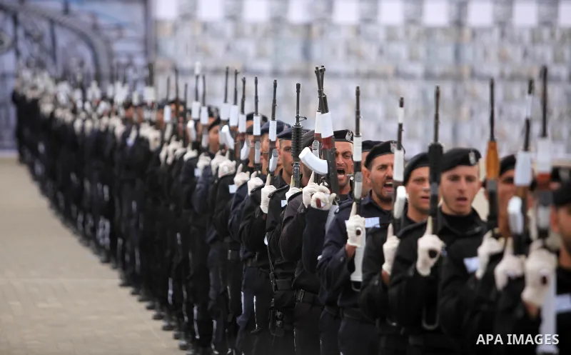 Palestinian policemen march during a graduation ceremony in Gaza City on January 21, 2017. Photo by Ashraf Amra