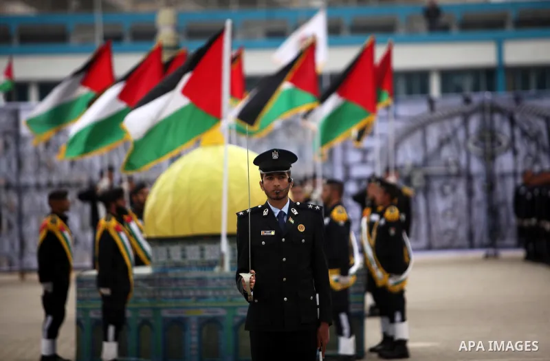 Palestinian policemen march during a graduation ceremony in Gaza City on January 21, 2017. Photo by Ashraf Amra