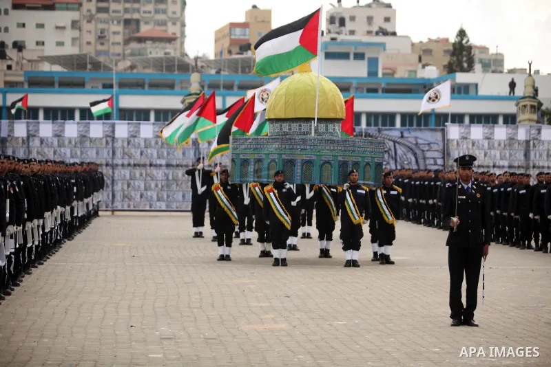Palestinian policemen march during a graduation ceremony in Gaza City on January 21, 2017. Photo by Ashraf Amra