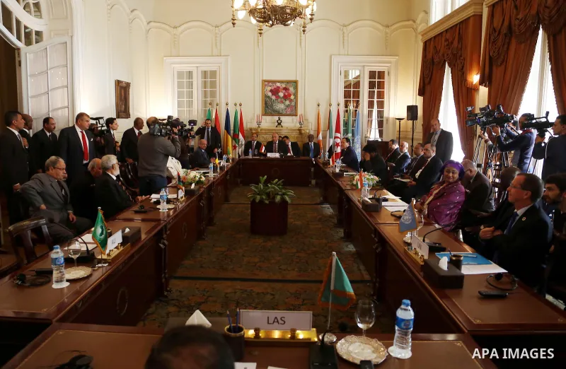 Libyan Foreign Minister, Mohamed Taher Siala, top center, attends a ministerial meeting of countries neighboring Libya which include Egypt, Tunisia, Algeria, Sudan, Niger and Chad, as well as United Nations envoy, Martin...