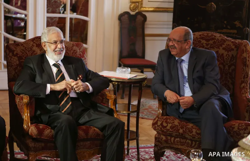 Libyan Foreign Minister, Mohamed Taher Siala, left, talks to Abdelkader Messahel, Algeria's Minister for African and Maghreb affairs, during a meeting over the political and economical turmoil in Libya on January 21, 201...
