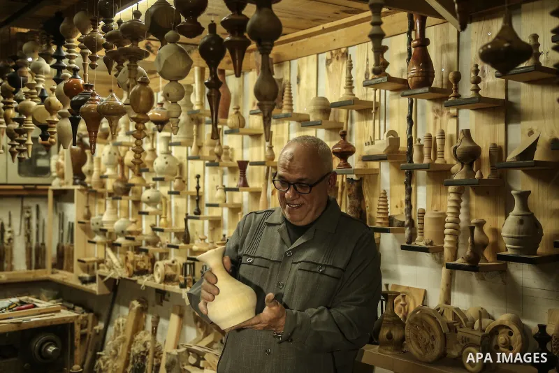 Palestinian man Hisham Kuhail arranges wooden decorative objects he carved for sale, at his workshop in Gaza City January 21, 2017. Photo by Mohammed Dahman