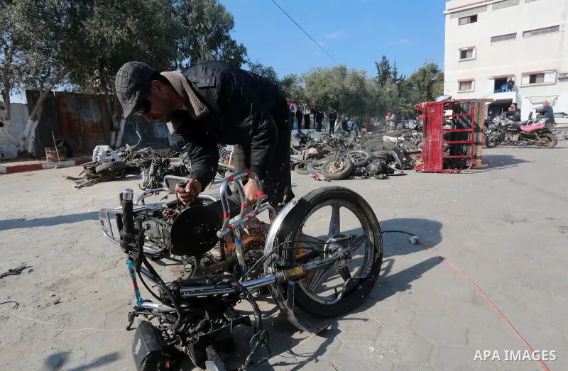A Palestinian policeman destroys illegal motorcycles in Gaza city on January 22, 2017. According to Palestinian traffic police more than 70 motorcycle and 1500 Gas device will be destroyed. Photo by Mohammed Asad