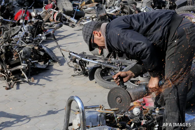 A Palestinian policeman destroys illegal motorcycles in Gaza city on January 22, 2017. According to Palestinian traffic police more than 70 motorcycle and 1500 Gas device will be destroyed. Photo by Mohammed Asad