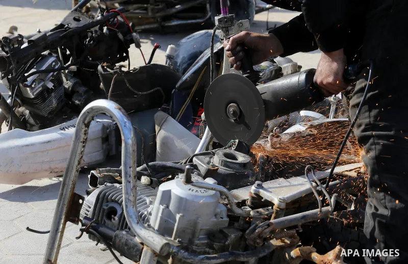 A Palestinian policeman destroys illegal motorcycles in Gaza city on January 22, 2017. According to Palestinian traffic police more than 70 motorcycle and 1500 Gas device will be destroyed. Photo by Mohammed Asad