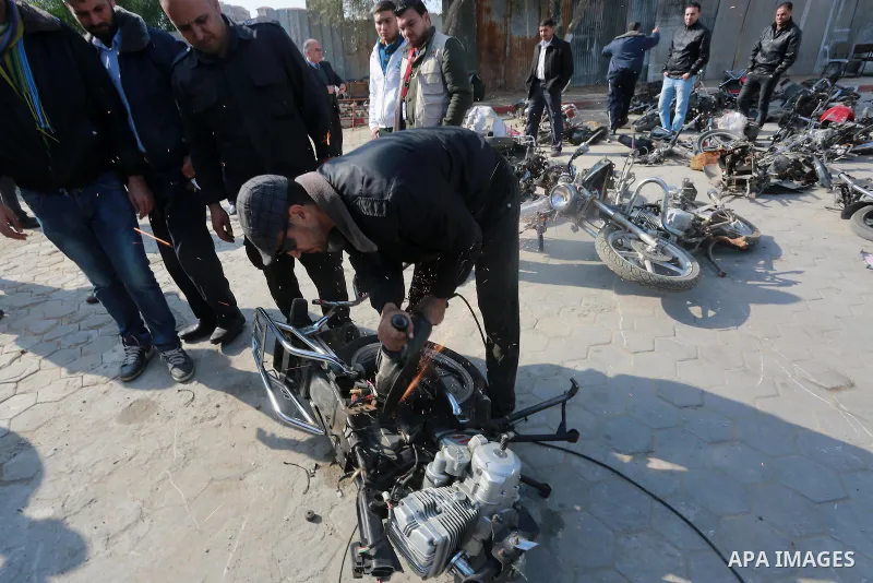 A Palestinian policeman destroys illegal motorcycles in Gaza city on January 22, 2017. According to Palestinian traffic police more than 70 motorcycle and 1500 Gas device will be destroyed. Photo by Mohammed Asad