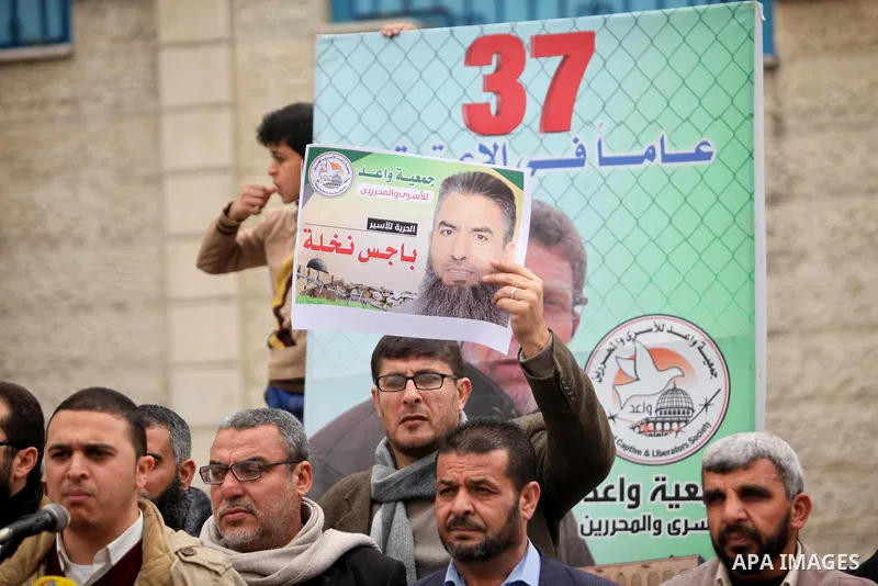 Palestinians hold placards during a protest to show solidarity with Palestinian prisoners in Israeli jails, in front of the high commissioner for human rights headquarters, in Gaza city, on January 26, 2017. Photo by Ash...