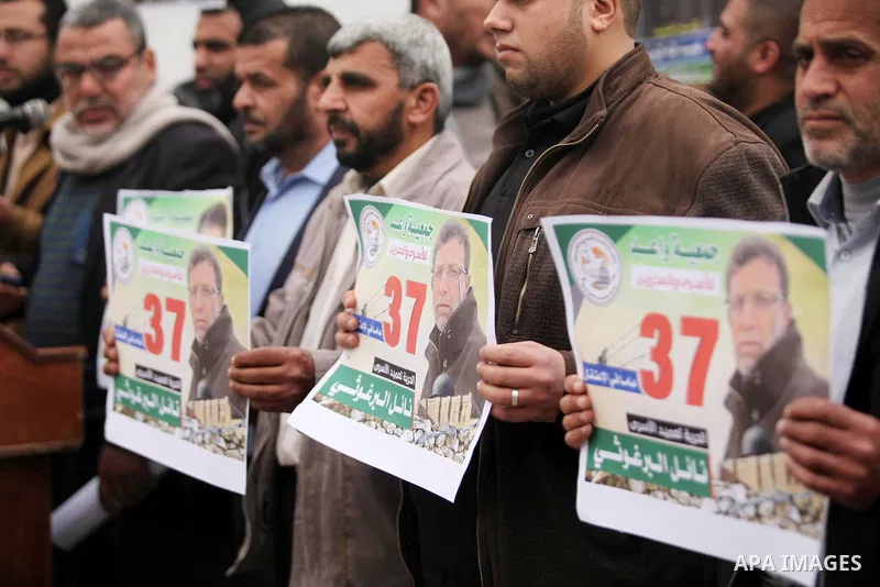 Palestinians hold placards during a protest to show solidarity with Palestinian prisoners in Israeli jails, in front of the high commissioner for human rights headquarters, in Gaza city, on January 26, 2017. Photo by Ash...