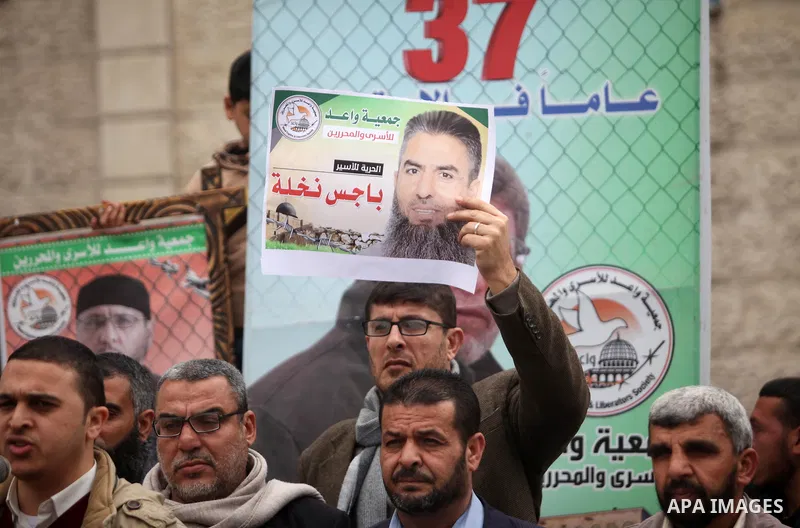 Palestinians hold placards during a protest to show solidarity with Palestinian prisoners in Israeli jails, in front of the high commissioner for human rights headquarters, in Gaza city, on January 26, 2017. Photo by Ash...