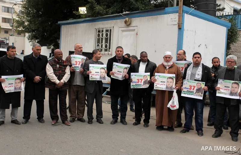 Palestinians hold placards during a protest to show solidarity with Palestinian prisoners in Israeli jails, in front of the high commissioner for human rights headquarters, in Gaza city, on January 26, 2017. Photo by Ash...