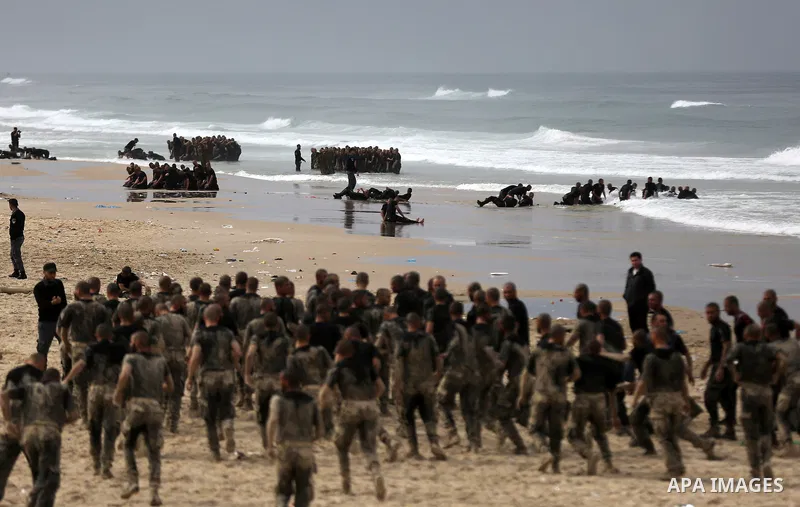 Members of Palestinian National Security Forces loyal to Hamas take part during a military training program, at the beach of the Mediterranean sea on the coast of Gaza city, on January 26, 2017. Photo by Yasser Qudih