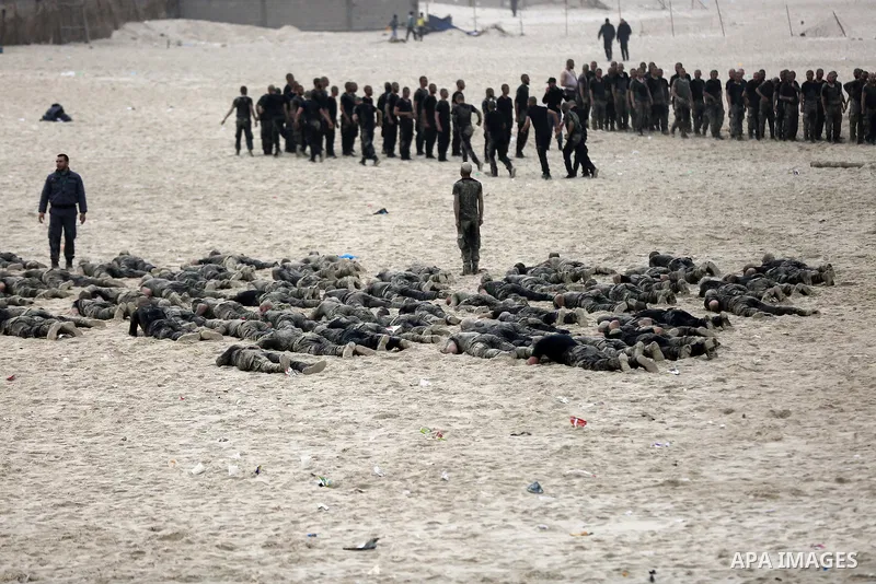 Members of Palestinian National Security Forces loyal to Hamas take part during a military training program, at the beach of the Mediterranean sea on the coast of Gaza city, on January 26, 2017. Photo by Yasser Qudih