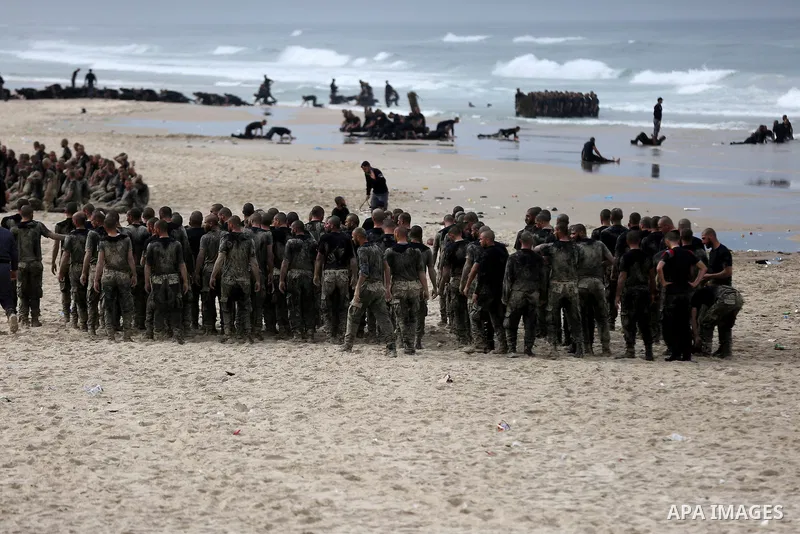 Members of Palestinian National Security Forces loyal to Hamas take part during a military training program, at the beach of the Mediterranean sea on the coast of Gaza city, on January 26, 2017. Photo by Yasser Qudih