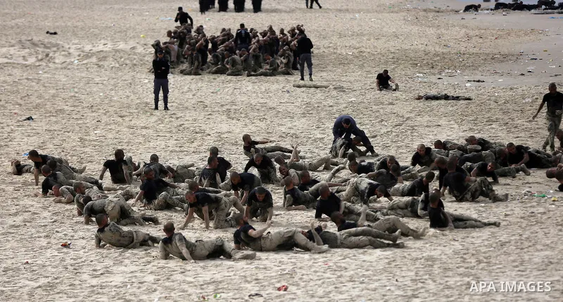 Members of Palestinian National Security Forces loyal to Hamas take part during a military training program, at the beach of the Mediterranean sea on the coast of Gaza city, on January 26, 2017. Photo by Yasser Qudih