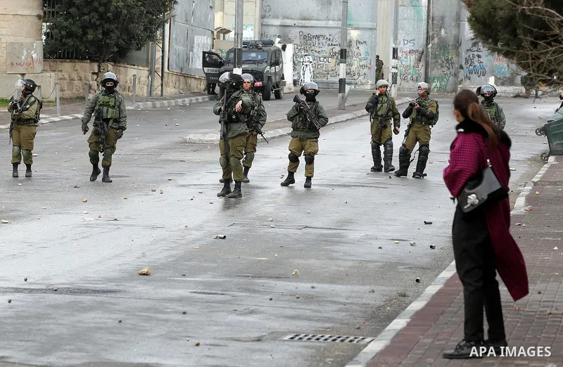 Israeli security forces take position during clashes with Palestinian protesters following a demonstration demanding that Israeli authorities return the bodies of Palestinians killed during attacks on Israel, in the West...