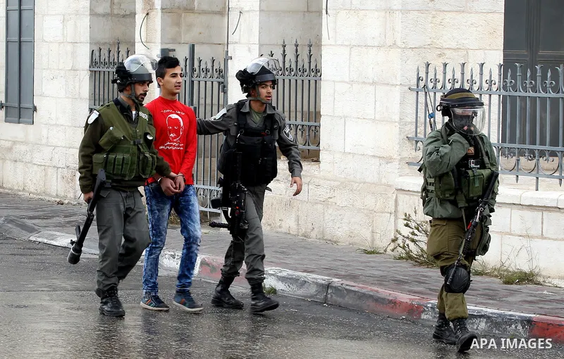 Israeli border policemen detain a Palestinian during clashes following a demonstration demanding that Israeli authorities return the bodies of Palestinians killed during attacks on Israel, in the West Bank town of Bethle...