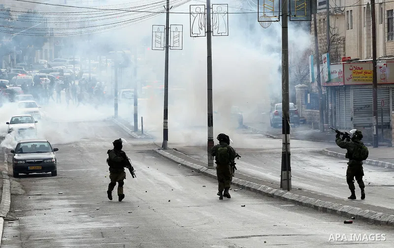 Israeli security forces take position during clashes with Palestinian protesters following a demonstration demanding that Israeli authorities return the bodies of Palestinians killed during attacks on Israel, in the West...