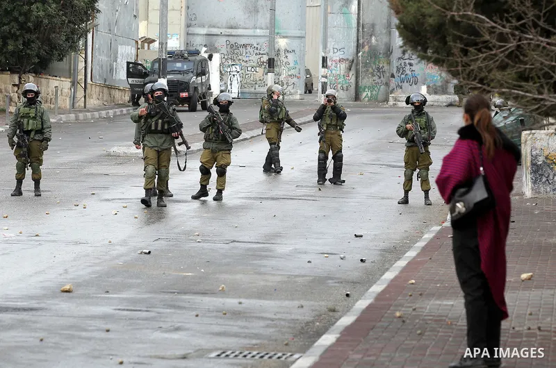 Israeli security forces take position during clashes with Palestinian protesters following a demonstration demanding that Israeli authorities return the bodies of Palestinians killed during attacks on Israel, in the West...