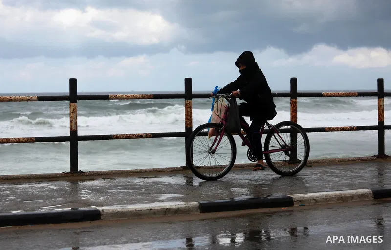 A Palestinian boy rides a bicycle at a flooded street during a rainy and heavy wind weather prevails on the Mediterranean Sea, at Shati refugee camp in Gaza City on January 28, 2017. Photo by Mohammed Asad