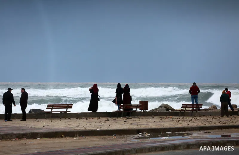 Palestinian girls take a selfie at the Gaza seaport during a rainy and heavy wind weather prevails on the Mediterranean Sea, in Gaza City on January 28, 2017. Photo by Mohammed Asad