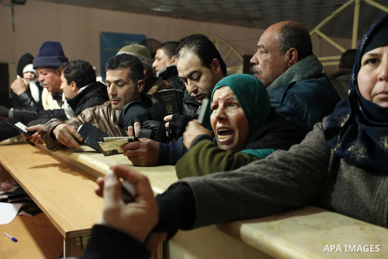 Palestinians wait for travel permits to cross into Egypt through the Rafah border crossing after it was opened by Egyptian authorities for humanitarian cases, in Rafah in the southern Gaza Strip January 28, 2017. Photo b...