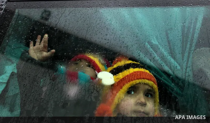 Palestinian boys sit in a bus as they wait to cross into Egypt through the Rafah border crossing after it was opened by Egyptian authorities for humanitarian cases, in Rafah in the southern Gaza Strip January 28, 2017. P...
