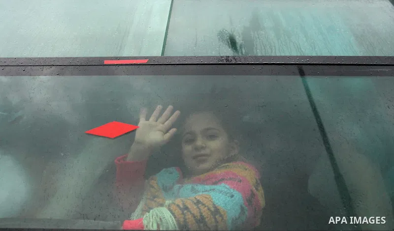 A Palestinian girl sits in a bus as they wait to cross into Egypt through the Rafah border crossing after it was opened by Egyptian authorities for humanitarian cases, in Rafah in the southern Gaza Strip January 28, 2017...