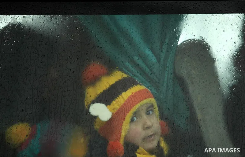 A Palestinian boy sits in a bus as they wait to cross into Egypt through the Rafah border crossing after it was opened by Egyptian authorities for humanitarian cases, in Rafah in the southern Gaza Strip January 28, 2017....