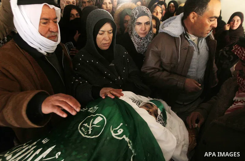 Relatives of Majd al-Khudur, a Palestinian woman who was killed by Israeli security forces during a car-ramming attack last year, mourns during her funeral in the West Bank village of Bani Naim near Hebron on January 28,...