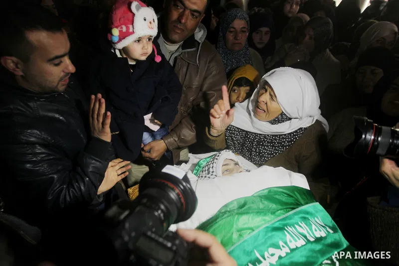 Relatives of Majd al-Khudur, a Palestinian woman who was killed by Israeli security forces during a car-ramming attack last year, mourns during her funeral in the West Bank village of Bani Naim near Hebron on January 28,...