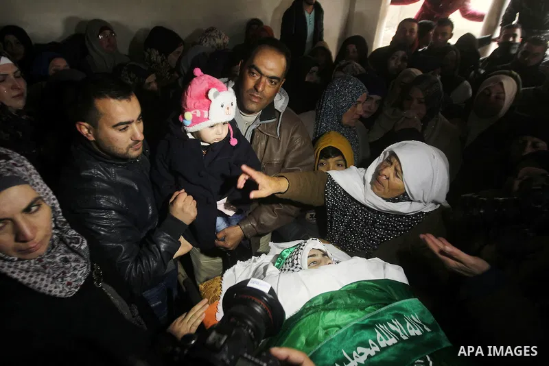 Relatives of Majd al-Khudur, a Palestinian woman who was killed by Israeli security forces during a car-ramming attack last year, mourns during her funeral in the West Bank village of Bani Naim near Hebron on January 28,...