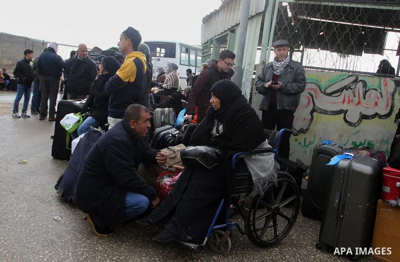 Palestinians wait for travel permits to cross into Egypt through the Rafah border crossing after it was opened by Egyptian authorities for humanitarian cases, in Rafah in the southern Gaza Strip, on January 29, 2017. Pho...