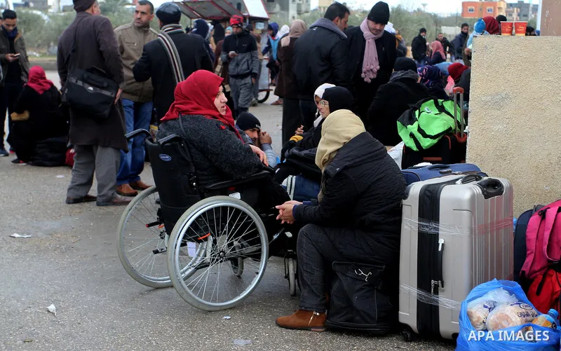 Palestinians wait for travel permits to cross into Egypt through the Rafah border crossing after it was opened by Egyptian authorities for humanitarian cases, in Rafah in the southern Gaza Strip, on January 29, 2017. Pho...