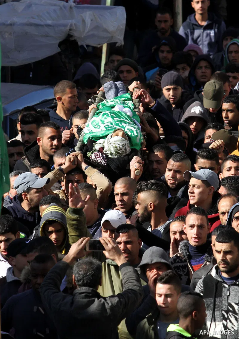 Mourners carry the body of Palestinian Mohammed Abu Khalifa, during his funeral at the Jenin refugee camp, near the West Bank city of Jenin, on January 29, 2017. A Palestinian was shot dead and five others were wounded b...