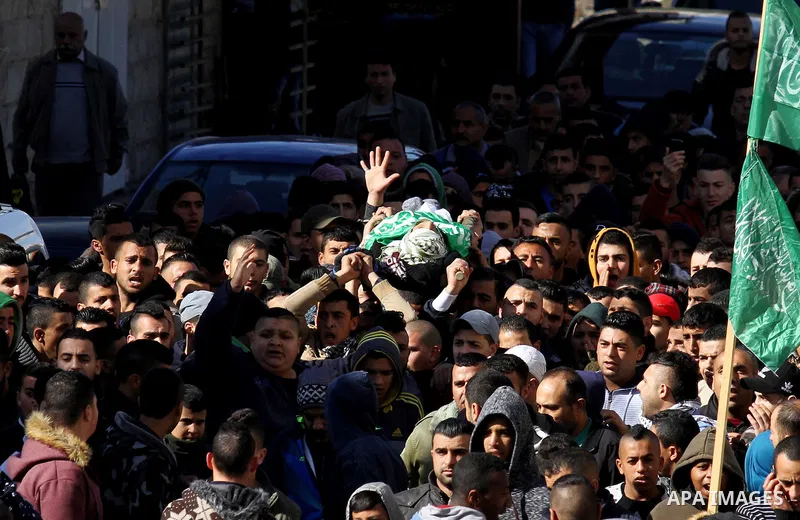 Mourners carry the body of Palestinian Mohammed Abu Khalifa, during his funeral at the Jenin refugee camp, near the West Bank city of Jenin, on January 29, 2017. A Palestinian was shot dead and five others were wounded b...