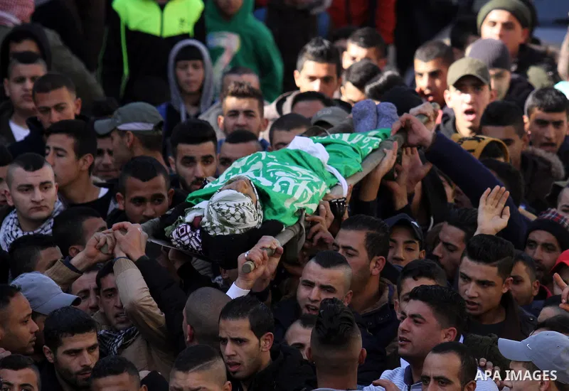 Mourners carry the body of Palestinian Mohammed Abu Khalifa, during his funeral at the Jenin refugee camp, near the West Bank city of Jenin, on January 29, 2017. A Palestinian was shot dead and five others were wounded b...