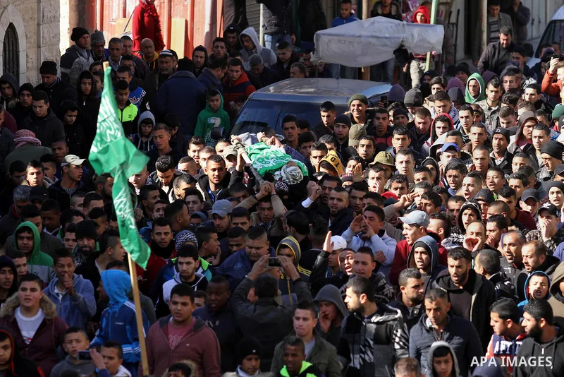 Mourners carry the body of Palestinian Mohammed Abu Khalifa, during his funeral at the Jenin refugee camp, near the West Bank city of Jenin, on January 29, 2017. A Palestinian was shot dead and five others were wounded b...