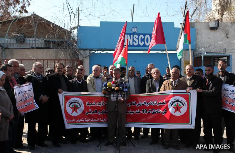 Palestinian supporters of the Democratic Front for the Liberation of Palestine (DFLP) take part during a protest to show solidarity with Palestinian in Bedouin village of Umm al-Hiran, in front of United Nation headquart...
