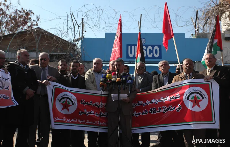 Palestinian supporters of the Democratic Front for the Liberation of Palestine (DFLP) take part during a protest to show solidarity with Palestinian in Bedouin village of Umm al-Hiran, in front of United Nation headquart...