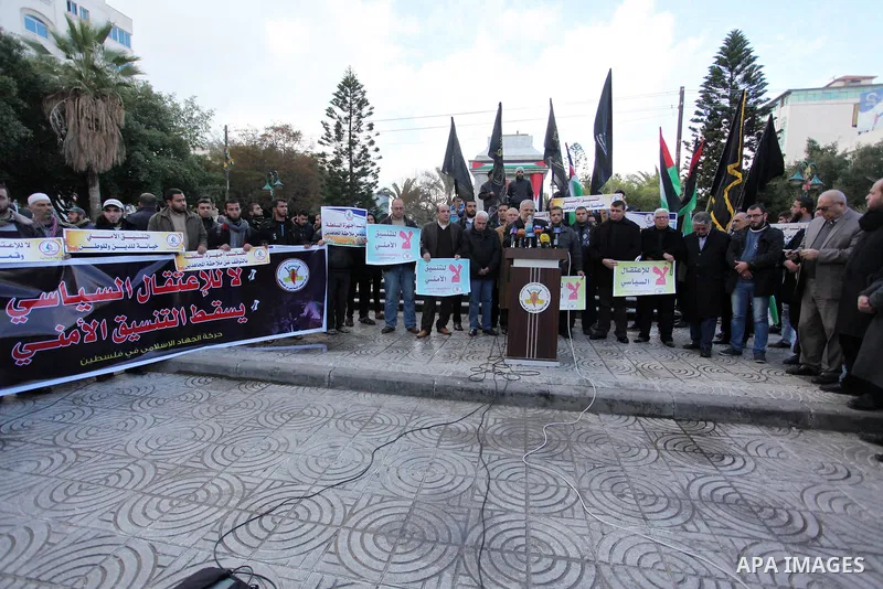 Palestinian supporters of the Islamic Jihad Movement hold placards during a protest against the security coordination and the political arrests in the West Bank, in Gaza city on January 31, 2017. Photo by Ashraf Amra