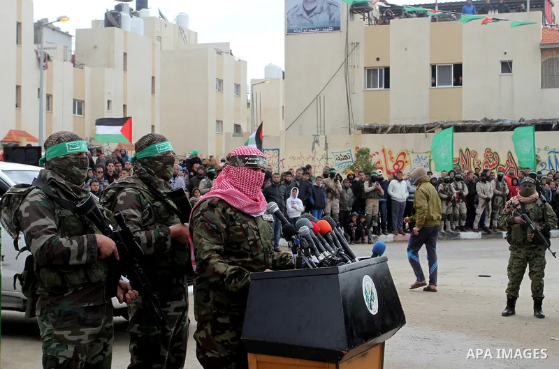 Abu Ubaida, spokesman of the Ezzedine al-Qassam Brigades, the military wing of the Palestinian Islamist movement Hamas, speaks during a memorial in Rafah in the southern Gaza Strip on January 31, 2017, for Mohamed Zouari...