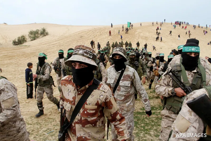 Members of the Ezzedine al-Qassam Brigades, the military wing of the Palestinian Islamist movement Hamas, attend a memorial in Rafah in the southern Gaza Strip on January 31, 2017, for Mohamed Zouari, a 49-year-old Tunis...