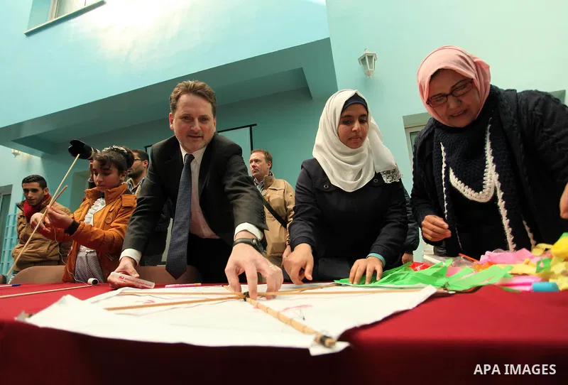 Commissioner-General of the UN Relief and Works Agency (UNRWA) Pierre Krahenbuhl, helps Palestinian students to prepare kites at the headquarters United Nations Relief and Works Agency (UNRWA), in Gaza city, on Feb. 01,...