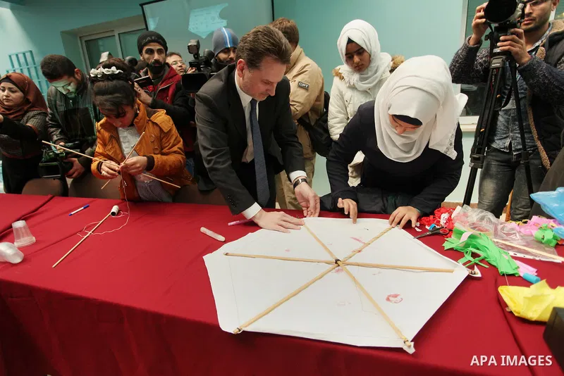 Commissioner-General of the UN Relief and Works Agency (UNRWA) Pierre Krahenbuhl, helps Palestinian students to prepare kites at the headquarters United Nations Relief and Works Agency (UNRWA), in Gaza city, on Feb. 01,...