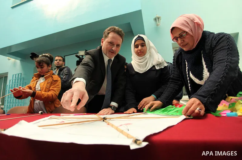 Commissioner-General of the UN Relief and Works Agency (UNRWA) Pierre Krahenbuhl, helps Palestinian students to prepare kites at the headquarters United Nations Relief and Works Agency (UNRWA), in Gaza city, on Feb. 01,...