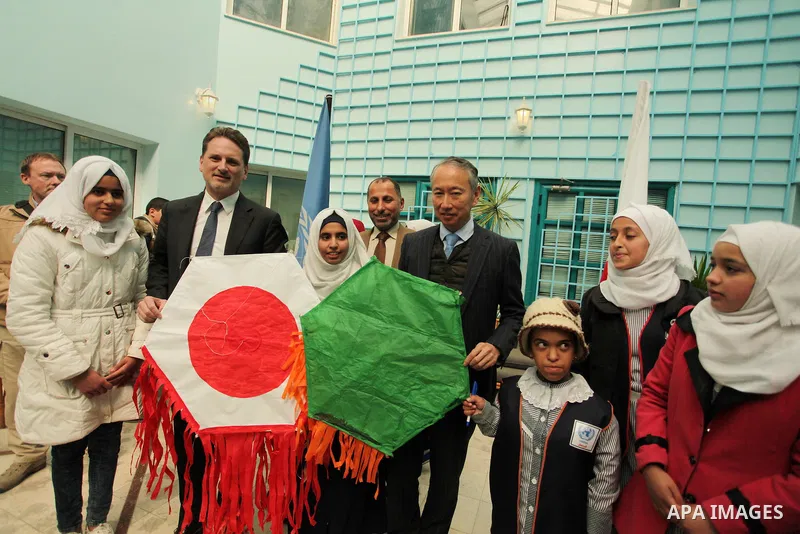 Japanese Ambassador to Palestine, Takeshi Okubo, and Commissioner-General of the UN Relief and Works Agency (UNRWA) Pierre Krahenbuhl, help Palestinian students to prepare kites at the headquarters United Nations Relief...