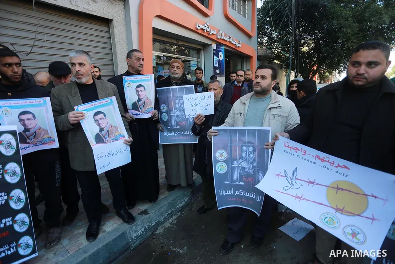 Palestinians hold placards during a protest to show solidarity with Palestinian prisoners held in Israeli Jails, in Gaza city, on February 2, 2017. Photo by Mohammed Asad