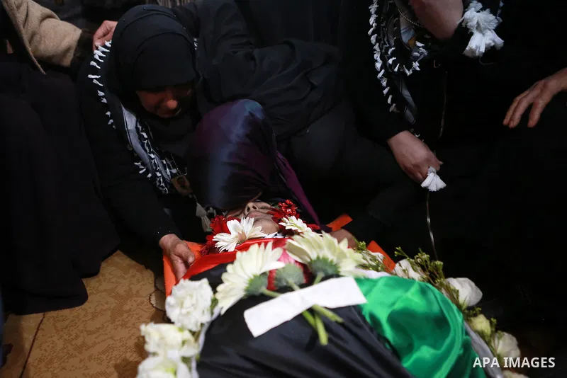 Relatives of Mohammad Zeidan, 16, a Palestinian youth who was killed by Israeli security forces on Nov. 25 after allegedly attempting to carry out a stabbing attack mourn during his funeral in the West Bank village of Bi...