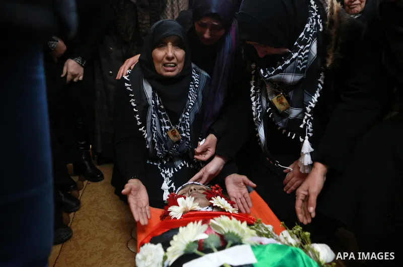 Relatives of Mohammad Zeidan, 16, a Palestinian youth who was killed by Israeli security forces on Nov. 25 after allegedly attempting to carry out a stabbing attack mourn during his funeral in the West Bank village of Bi...